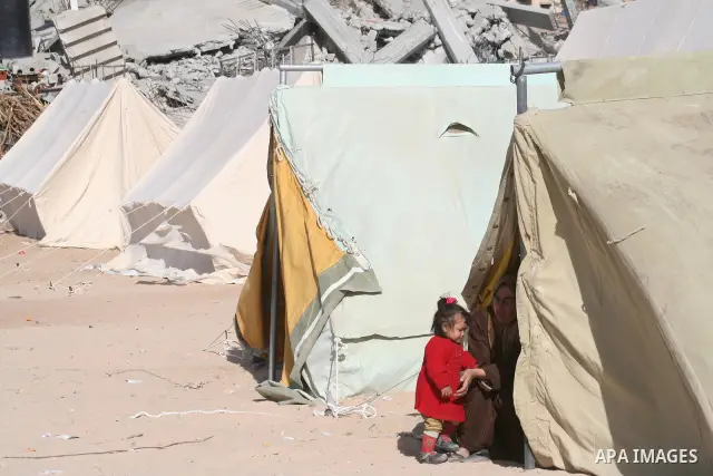 A Palestinian woman and her daughter sit at the entrance of a tent serving as temporary shelter after their house was destroyed during the 22-day Israeli offensive in Jabalia in the northern Gaza Strip on January 31, 200...