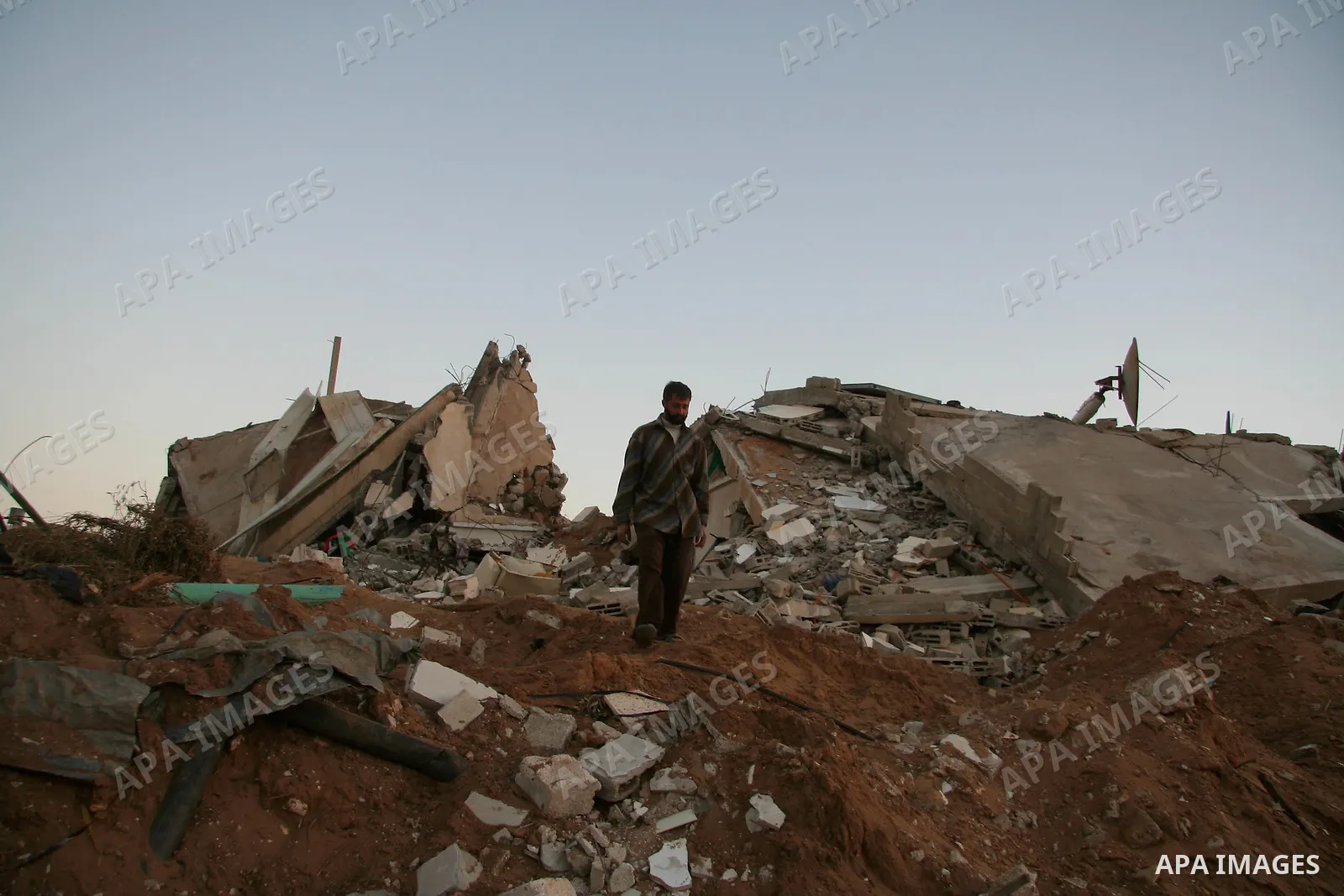 A Palestinian man inspects his destroyed house after an Israeli operation in the northern Gaza Strip, 04 February 2009. Israeli planes have bombed smuggling tunnels on Gaza's border with Egypt, the Israeli military atate...