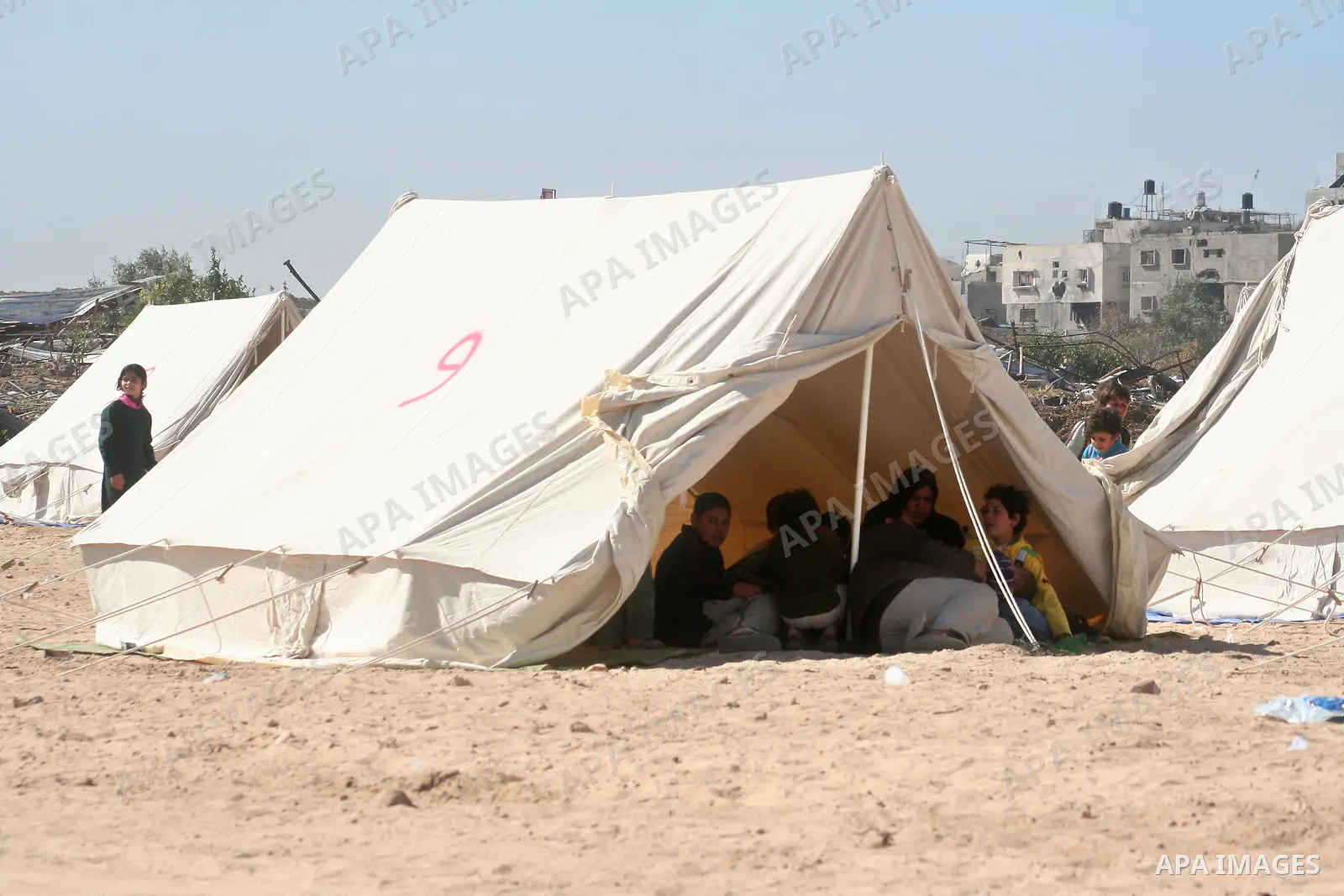 Palestinians stand in front of tents near their destroyed house in Jabalya in the northern Gaza Strip January 4, 2009. APAIMAGES PHOTO / Ashraf Amra