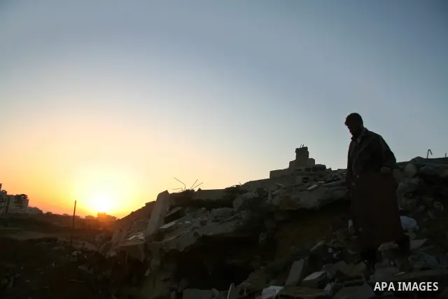 A Palestinian man inspects his destroyed house after an Israeli operation in the northern Gaza Strip, 04 February 2009. Israeli planes have bombed smuggling tunnels on Gaza's border with Egypt, the Israeli military atate...