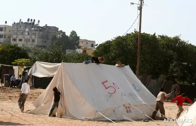 A Palestinian family in a tent for families whose homes were destroyed during the 22-day Israeli offensive in the east of Jabaliya refugee camp in the northern Gaza Strip on 07 February 2009, APAIMAGES PHOTO / Ashraf Amr...