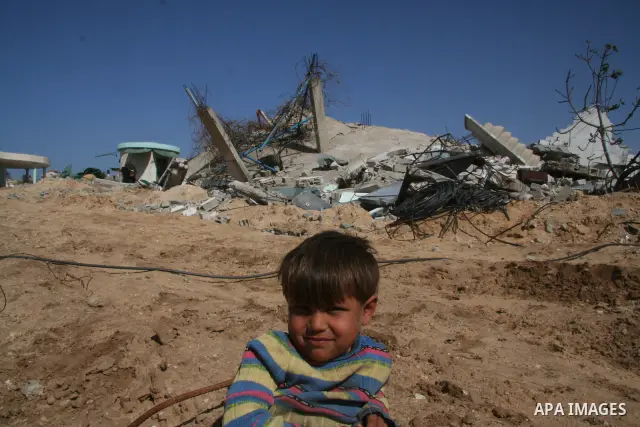 A Palestinian boy walks through his destroyed home in the east of Jabaliya refugee camp in the northern Gaza Strip, 15 February 2009 APAIMAGES PHOTO / Ashraf Amra