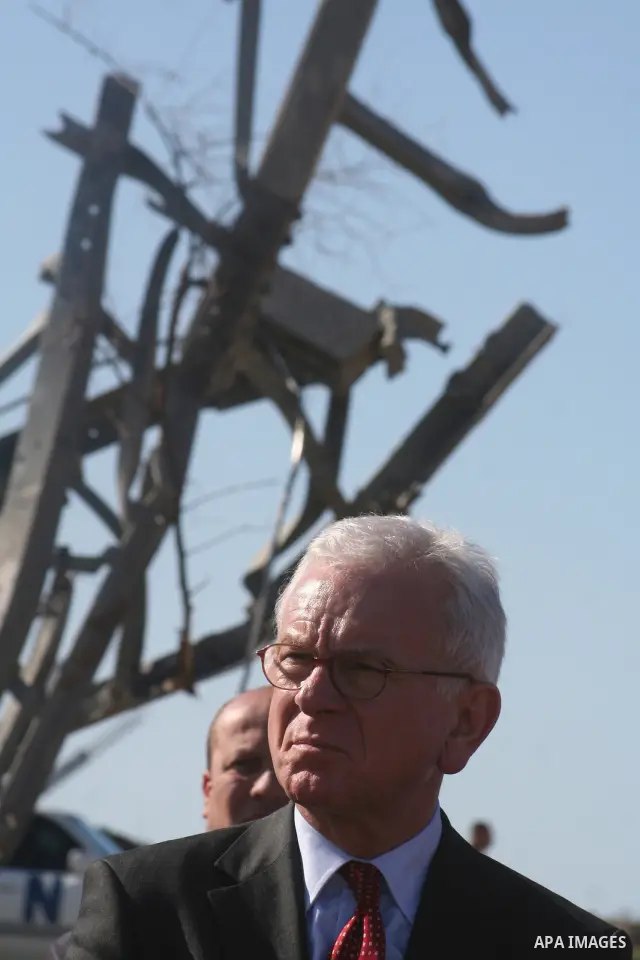 European Union (EU) Parliament President Hans-Gert Poettering (R) hold hands with a Palestinian man during a visit to a Jabalia district that was bombed during Israel's 22-day offensive on the Gaza Strip, on February 23,...