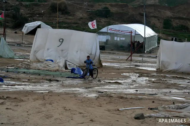 A Palestinian evacuates his belongings from a tent that housed people who have lost their homes during Israel's 22-day offensive, after heavy rain in east of Gaza March 1, 2009. The World Bank said on Sunday it would urg...