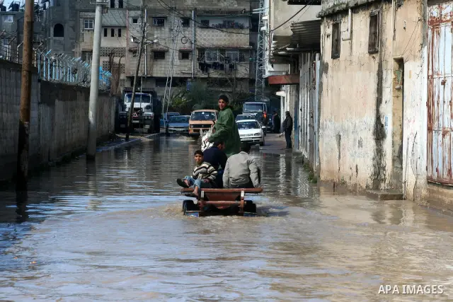 Palestinians ride on a horse cart after heavy rain in Gaza March 1, 2009. The World Bank said on Sunday it would urge international financial support for rebuilding the Gaza Strip through direct donation to both the West...