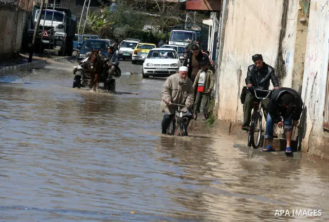 Palestinians ride on a horse cart after heavy rain in Gaza March 1, 2009. The World Bank said on Sunday it would urge international financial support for rebuilding the Gaza Strip through direct donation to both the West...