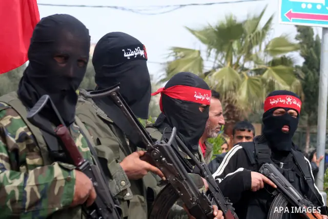 Palestinian militants from the Popular Front wait for the beginning of a funeral for two Palestinian militants in Deir Al-Balah, central Gaza Strip, Thursday, March 5, 2009. Israeli air strike early Thursday killed two I...