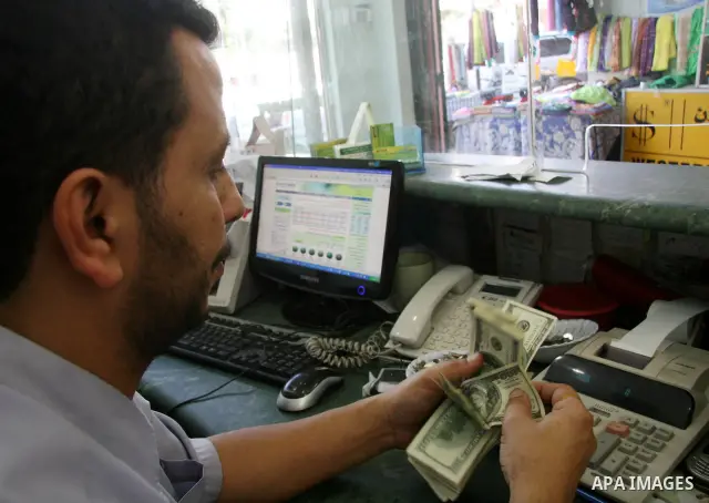 Palestinian man exchanges currencies in Gaza City. the U.S. dollar fall versus the shekel rise in black markets in the Gaza Strip, Hamas spokesman Fawzi Barhum said in a statement that the Financial crisis U.S.was due to...