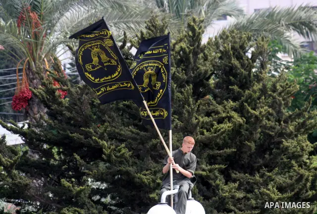 Palestinians supporting Hamas and Islamic Jihad hold Islamic flags during a rally marking Jerusalem Day at the Palestinian Legislative Council in Gaza City. Jerusalem's Al Aqsa Mosque is the third holiest site in the Mus...