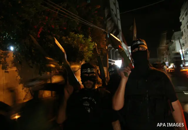 Palestinian militants of the Nasser Salah al-Din Brigades military wing of the Popular Resistance Committees take part in an annual march to mark the creation of their group in Gaza City.