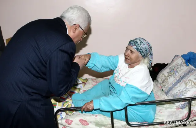 Palestinian President Mahmoud Abbas attends a collective breakfast at the house of elderly in the West Bank city of Ramallah.