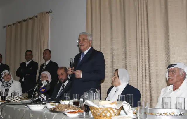 Palestinian President Mahmoud Abbas attends a collective breakfast at the house of elderly in the West Bank city of Ramallah.
