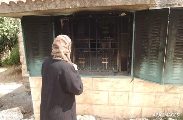 Palestinians inspect a burnt house after Israeli settlers burn house Mahmood An najar in Boreen village in the West Bank city of Nablus.