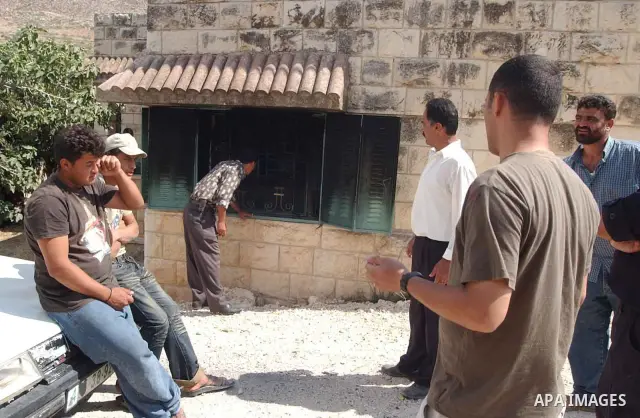 Palestinians inspect a burnt house after Israeli settlers burn house Mahmood An najar in Boreen village in the West Bank city of Nablus.