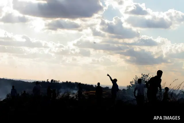 Palestinian youths hurl stones at Israeli soldiers during a demonstration against the construction of the controversial Israeli cement barrier in the West Bank village of Nilin near Ramallah.