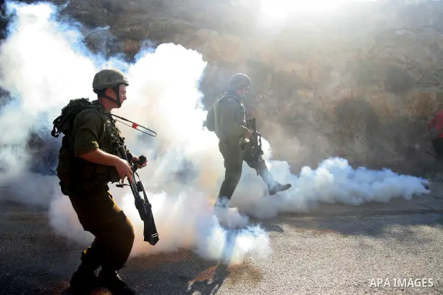 Israeli soldiers fire teargas and rubber bullets at Palestinian protestors during a demonstration against the construction of the controversial Israeli cement barrier in the West Bank village of Nilin near Ramallah.