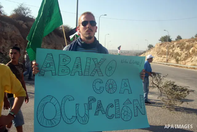 Palestinian protestors and foreign activists attend a demonstration against the construction of the controversial Israeli cement barrier in the West Bank village of Nilin near Ramallah.