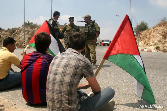 Israeli soldiers detain Palestinian and international protestors during a demonstration against the construction of the controversial Israeli cement barrier in the West Bank village of Nilin near Ramallah. Palestinian, I...