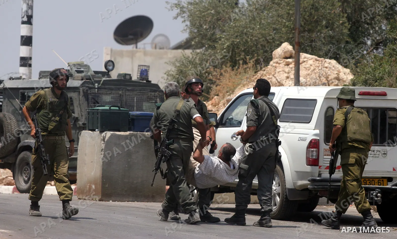 Israeli soldiers detain Palestinian and international protestors during a demonstration against the construction of the controversial Israeli cement barrier in the West Bank village of Nilin near Ramallah. Palestinian, I...