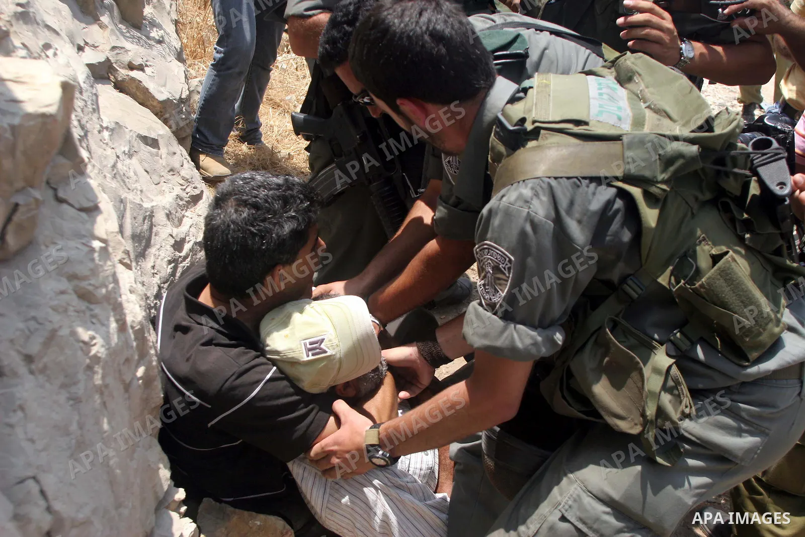 Israeli soldiers detain Palestinian and international protestors during a demonstration against the construction of the controversial Israeli cement barrier in the West Bank village of Nilin near Ramallah. Palestinian, I...