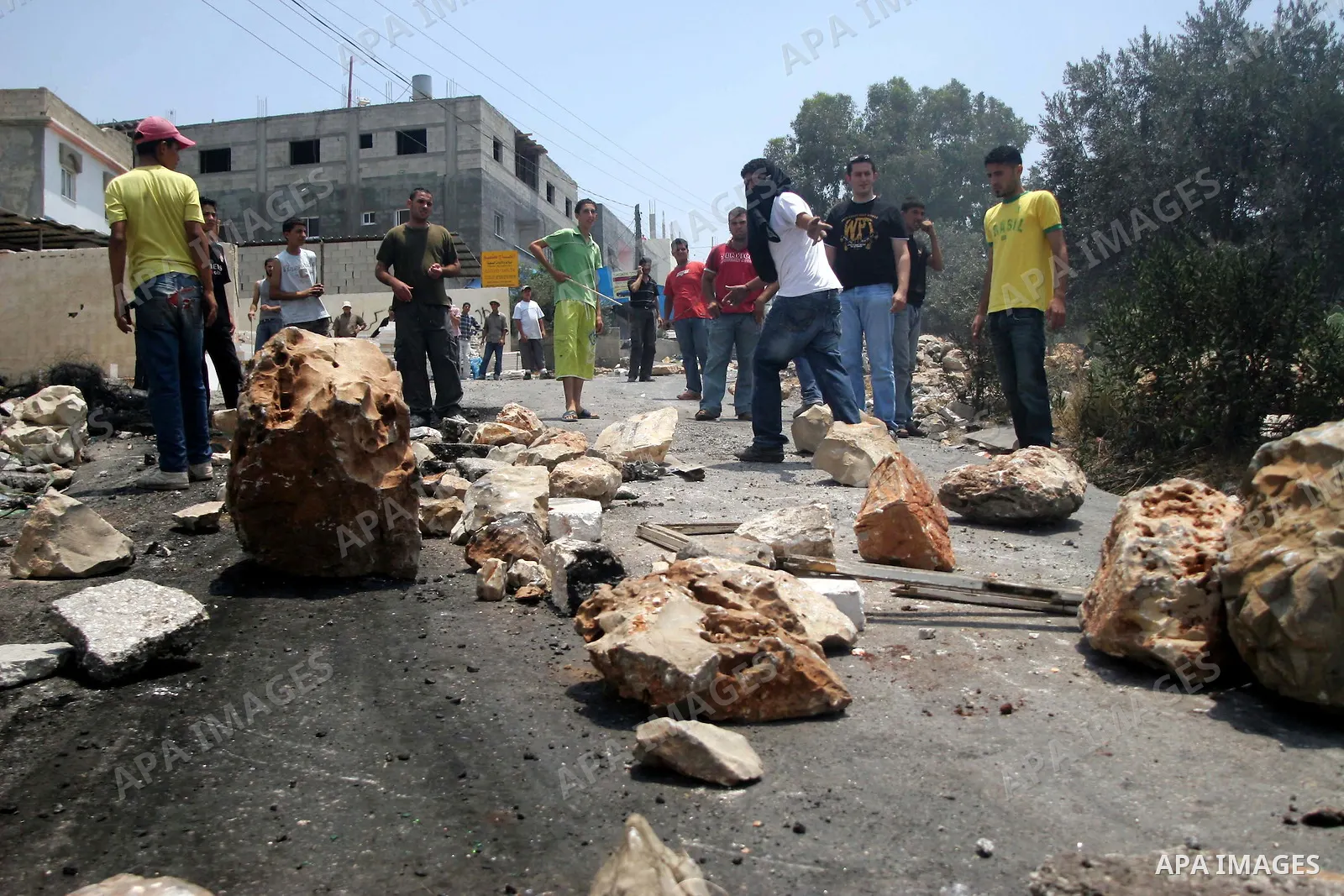 Palestinian youths hurl stones at Israeli soldiers during a demonstration against the construction of the controversial Israeli cement barrier in the West Bank village of Nilin near Ramallah.