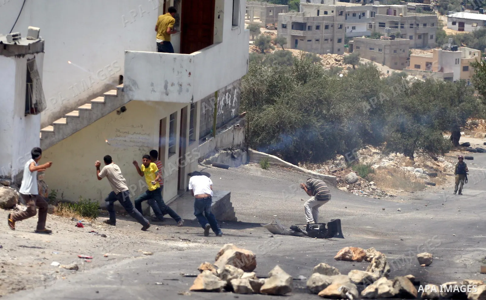 Israeli soldiers fire teargas and rubber bullets at Palestinian protestors during a demonstration against the construction of the controversial Israeli cement barrier in the West Bank village of Nilin near Ramallah.