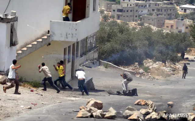 Israeli soldiers fire teargas and rubber bullets at Palestinian protestors during a demonstration against the construction of the controversial Israeli cement barrier in the West Bank village of Nilin near Ramallah.
