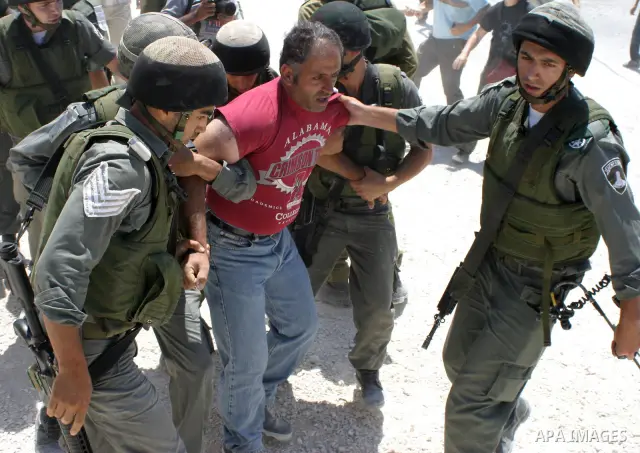 Israeli soldiers arrest Palestinian and foreign protestors against the construction of the controversial Israeli separation barrier in the village of Maasarah near the West Bank town of Bethlehem.