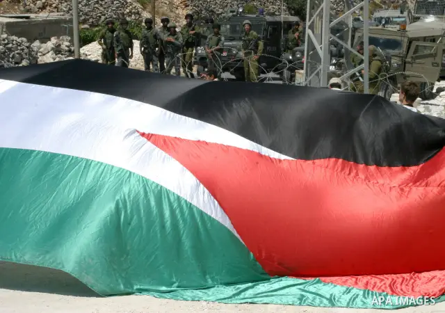 Israeli soldiers monitor a demonstration by Palestinian and foreign protestors against the construction of the controversial Israeli separation barrier in the village of Maasarah near the West Bank town of Bethlehem.