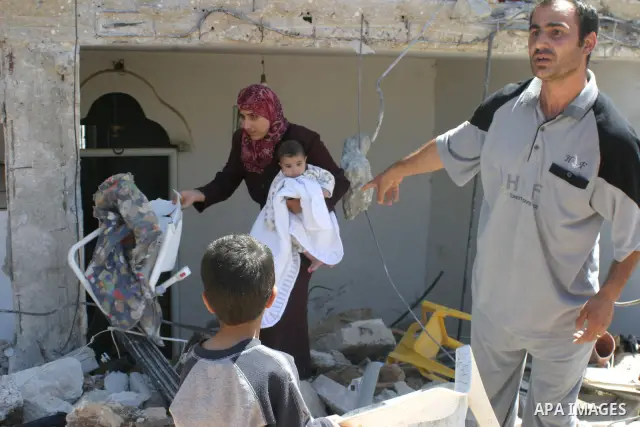 Palestinians react as they inspect their destroyed house of Jamal Karameh in the West Bank town of Hebron. According to Palestinian witnesses, Israeli forces raided two houses and arrested several men during an early mor...