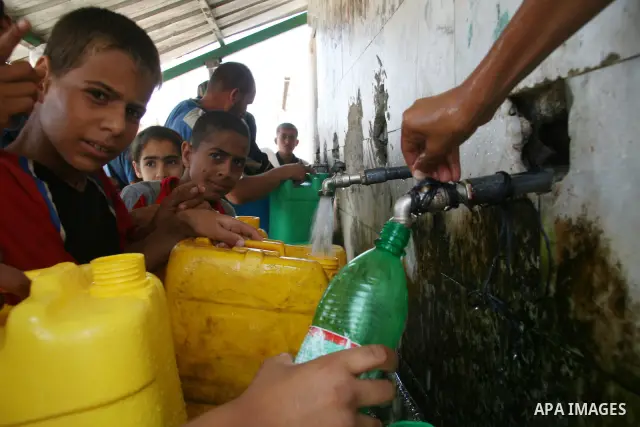 Palestinians fill their canisters a potable water at a water purification station, in Khan Younis town southern Gaza Strip. Palestinians suffer from the severe lack of potable water due to Israeli siege imposed on Gaza S...