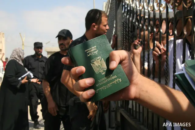 Palestinians wait at the gate of the Rafah border crossing to Egypt on July 1, 2008 in the southern Gaza Strip. Egypt opened the border crossing with Rafah on Tuesday for three days for the limited passage of people such...