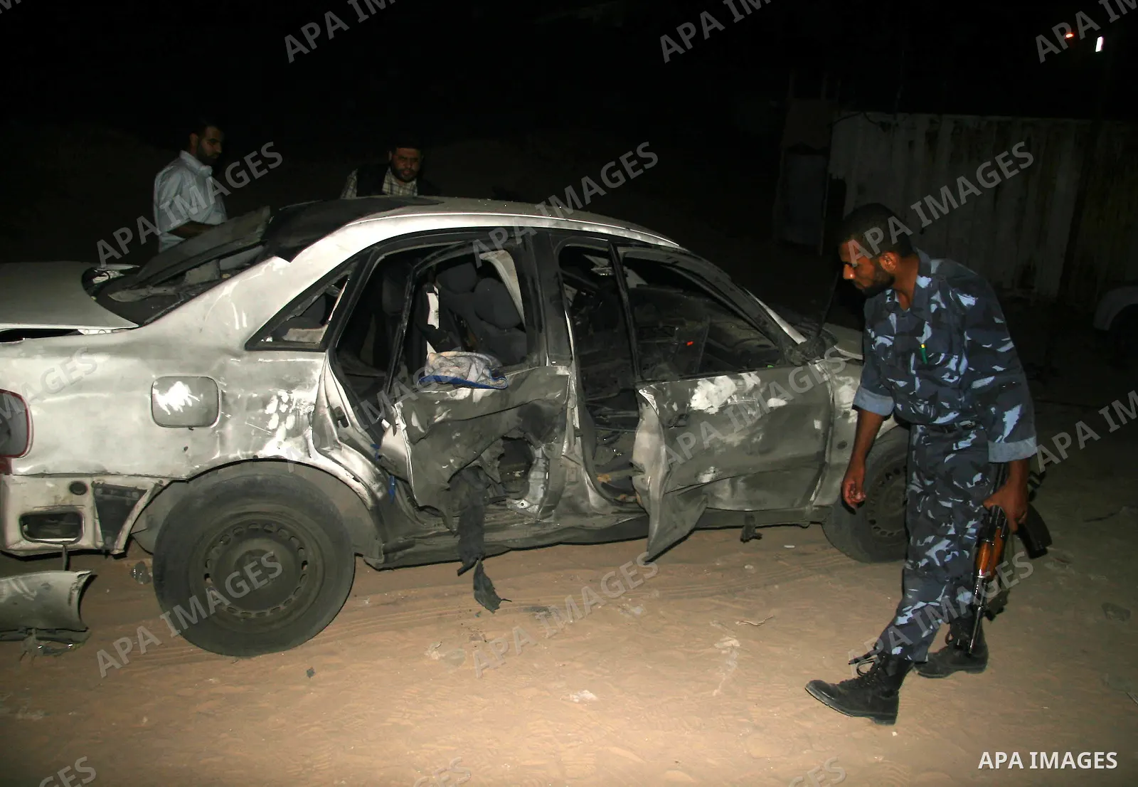 A Palestinian Hamas police officer inspects a damaged car following an explosion in Gaza City. Hamas-run security forces fanned out across Gaza City today, clashing with rival gunmen and arresting dozens of people after...
