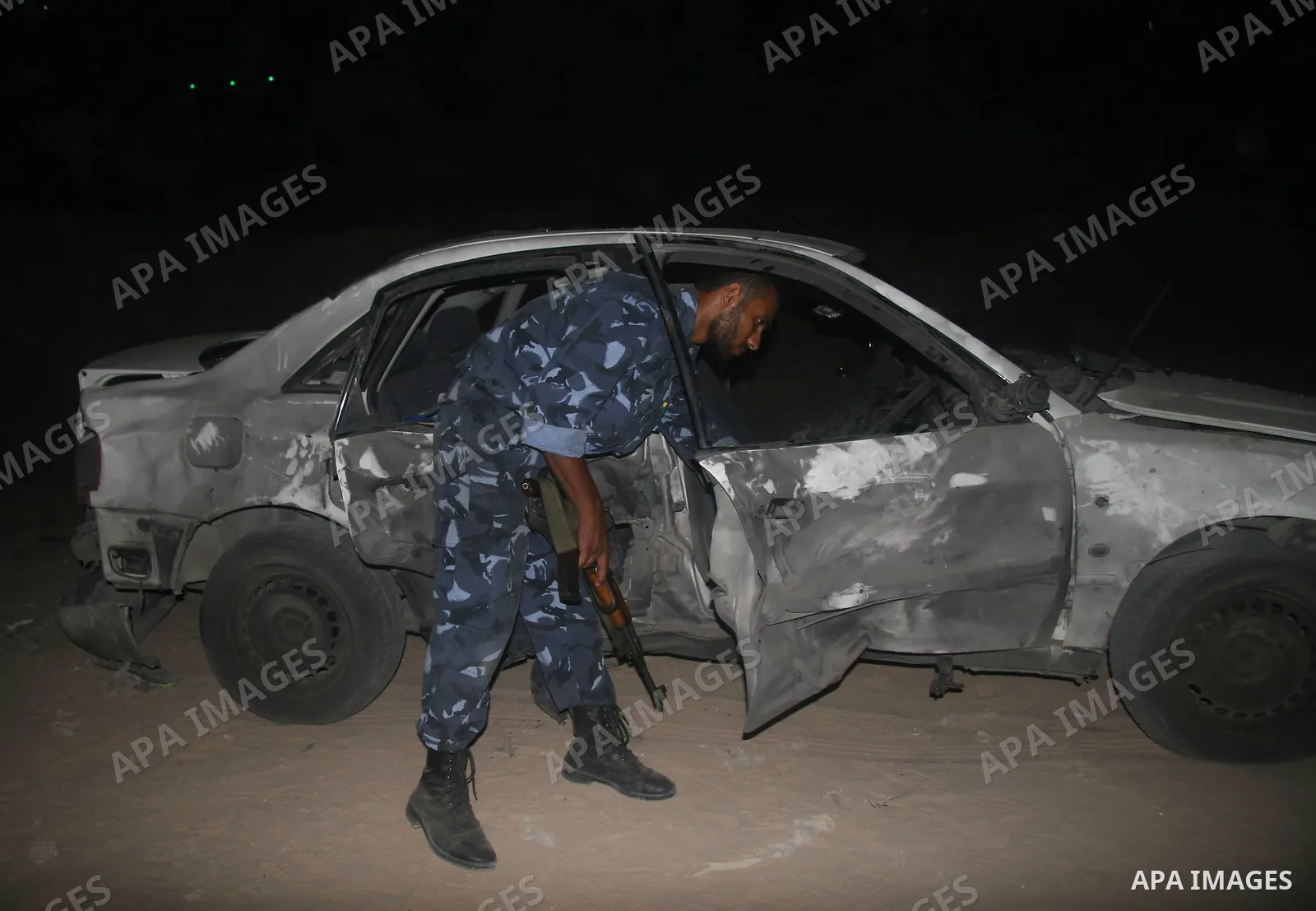 A Palestinian Hamas police officer inspects a damaged car following an explosion in Gaza City. Hamas-run security forces fanned out across Gaza City today, clashing with rival gunmen and arresting dozens of people after...