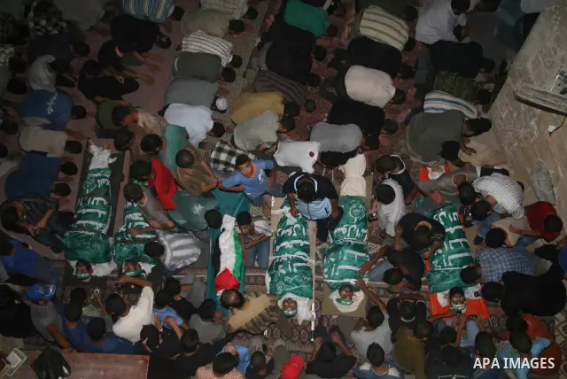 Palestinians mourn over the bodies of killed Hamas militants in a mosque in Gaza City, during a funeral after they were caught in an overnight bomb blast. Hamas-run security forces fanned out across Gaza City today, clas...