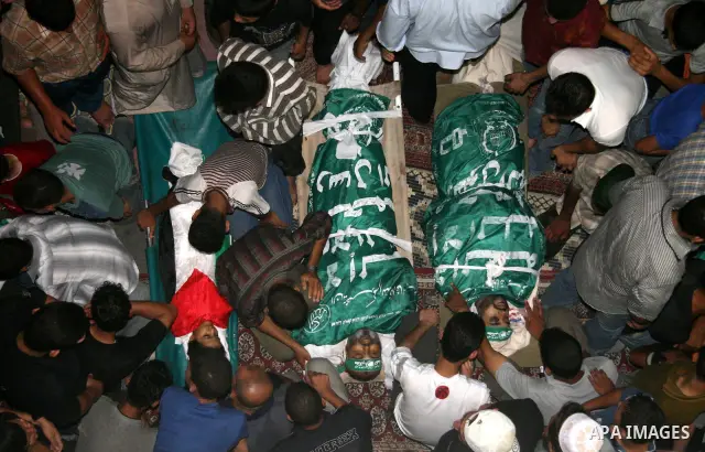 Palestinians mourn over the bodies of killed Hamas militants in a mosque in Gaza City, during a funeral after they were caught in an overnight bomb blast. Hamas-run security forces fanned out across Gaza City today, clas...