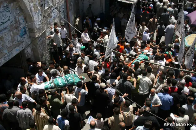 Palestinians carry the bodies of Hamas militants after they were killed in a bomb explosion at a major junction in the Hamas-ruled Gaza Strip. Hamas-run security forces fanned out across Gaza City today, clashing with ri...