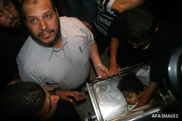 Senior member of Hamas Khalil al-Hayeh inspects the body of a Palestinian victim killed in an explosion, at Shifa hospital morgue in Gaza City. Hamas-run security forces fanned out across Gaza City today, clashing with r...