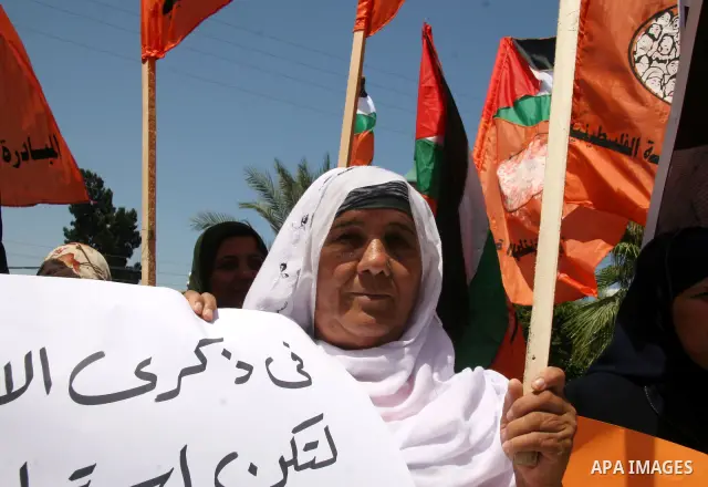 Palestinians hold their country's flag and placards as they attend a rally calling for the national conciliation and end the difference between Hamas and Fatah parties, in Gaza City.
