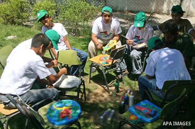 Palestinian teenagers make drawings as they attend a summer camp organized by Hamas in Gaza City.Thousands of Palestinian teenagers are taking part in summer camps organized by the Islamist movement.