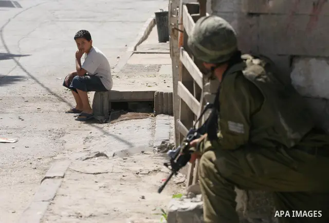 Israeli soldiers are seen during clashes with Palestinian youths near the construction site of Israel's controversial separation barrier in the West Bank village of Nilin, west of Ramallah. Israel says the barrier, which...