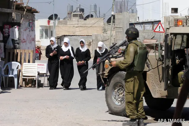 Israeli soldiers are seen during clashes with Palestinian youths near the construction site of Israel's controversial separation barrier in the West Bank village of Nilin, west of Ramallah. Israel says the barrier, which...