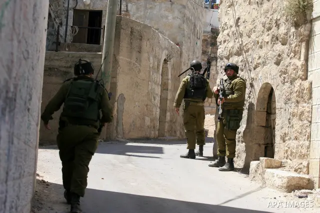 Israeli soldiers are seen during clashes with Palestinian youths near the construction site of Israel's controversial separation barrier in the West Bank village of Nilin, west of Ramallah. Israel says the barrier, which...