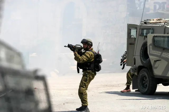 Israeli soldiers are seen during clashes with Palestinian youths near the construction site of Israel's controversial separation barrier in the West Bank village of Nilin, west of Ramallah. Israel says the barrier, which...