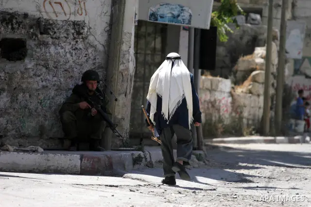 Israeli soldiers are seen during clashes with Palestinian youths near the construction site of Israel's controversial separation barrier in the West Bank village of Nilin, west of Ramallah. Israel says the barrier, which...