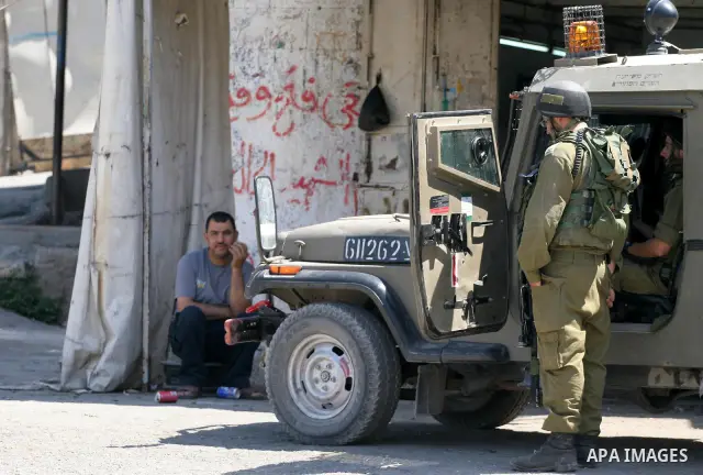 Israeli soldiers are seen during clashes with Palestinian youths near the construction site of Israel's controversial separation barrier in the West Bank village of Nilin, west of Ramallah. Israel says the barrier, which...