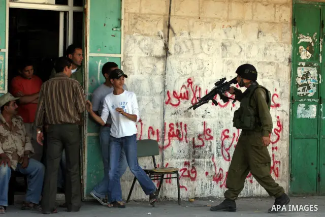 Israeli soldiers are seen during clashes with Palestinian youths near the construction site of Israel's controversial separation barrier in the West Bank village of Nilin, west of Ramallah. Israel says the barrier, which...