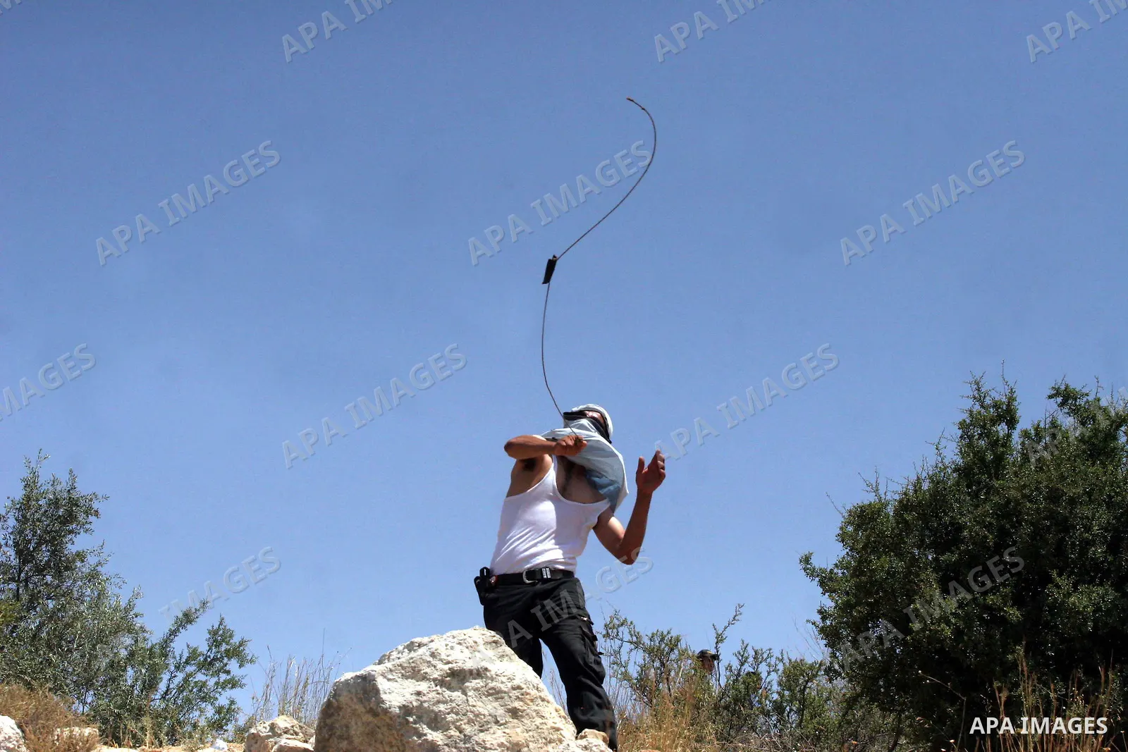 Palestinian youths throw stones at Israeli border police officers during a protest against the construction of Israel's controversial barrier in the West Bank village of Nilleen, near Ramallah.