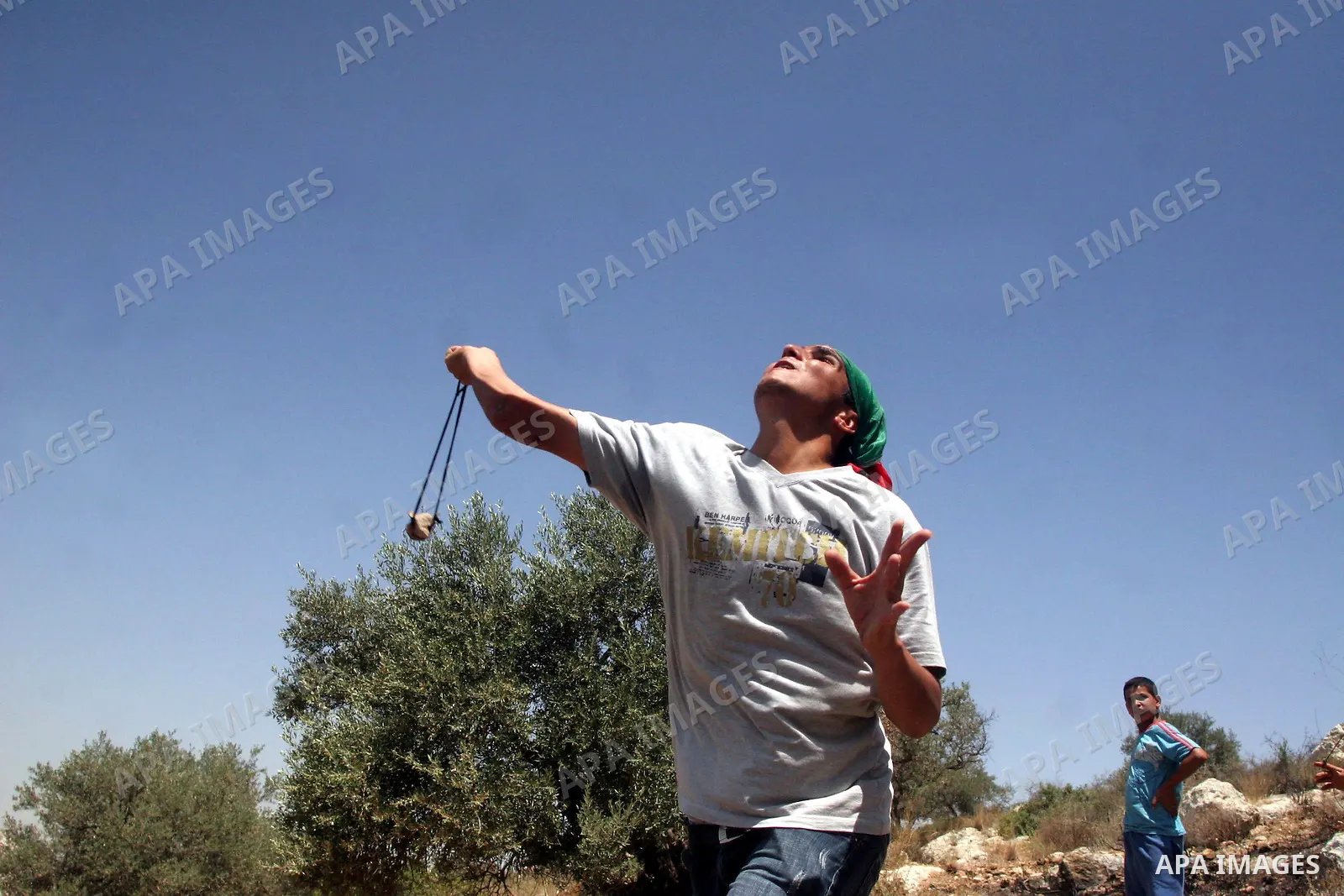 Palestinian youths throw stones at Israeli border police officers during a protest against the construction of Israel's controversial barrier in the West Bank village of Nilleen, near Ramallah.