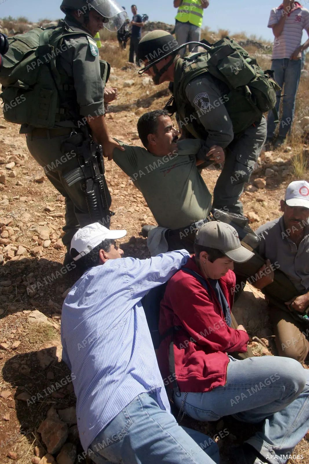 Israeli border police scuffle with Palestinians and international peace protesters during a demonstration against the construction of the controversial Israeli barrier in the West Bank village of Nilleen near Ramallah.